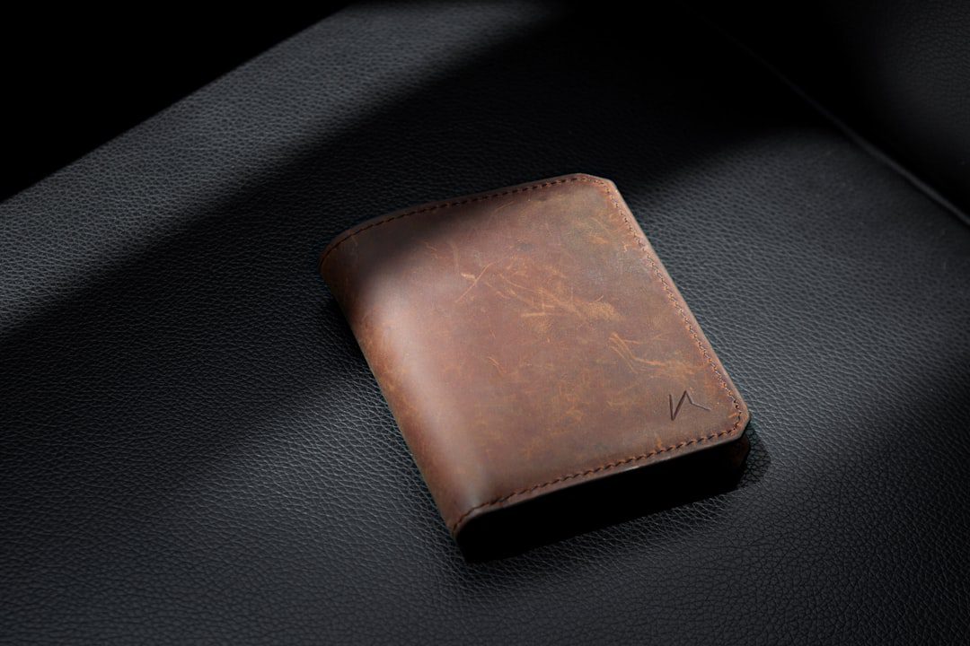 Brown leather wallet on a black surface for wallet colour Vastu guidance