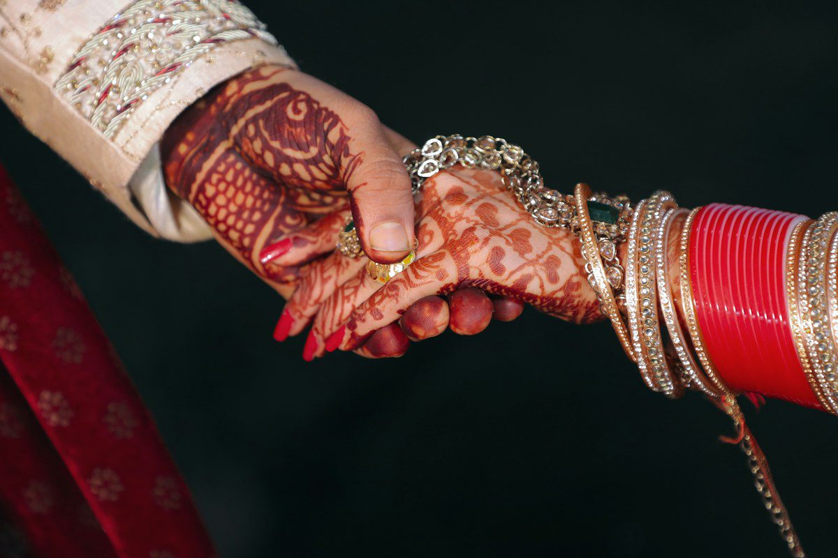 Indian wedding couple holding hands